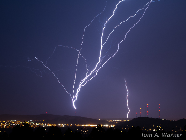 A flash of upward lightning -- with a triggering flash in the background (Credit: Tom A. Warner)